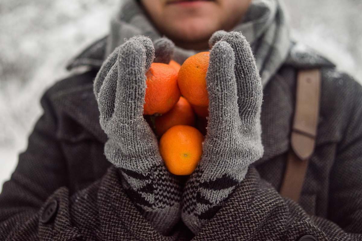 fruit person holding orange fruits food